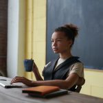 teacher sitting at desk